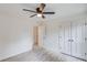 A well-lit bedroom with light wood-look floors, a ceiling fan, and white doors at 105 Simonton (Tract 1) Se Rd, Lawrenceville, GA 30046