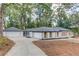 Side view of a well-maintained ranch home with a long driveway and detached garage at 105 Simonton (Tract 1) Se Rd, Lawrenceville, GA 30046
