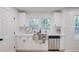 Bright kitchen with white cabinetry, stainless steel sink and appliances, and a subway tile backsplash at 105 Simonton (Tract 1) Se Rd, Lawrenceville, GA 30046
