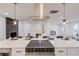 Modern kitchen featuring a large island cooktop, stainless appliances, and a stunning black marble fireplace at 105 Simonton (Tract 1) Se Rd, Lawrenceville, GA 30046