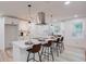 Modern kitchen with a large center island, stainless steel range hood, and wood-look flooring at 105 Simonton (Tract 1) Se Rd, Lawrenceville, GA 30046