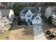 Aerial view of a two-story home with a manicured front lawn and two-car garage in a lush neighborhood at 10715 Glenbarr Dr, Johns Creek, GA 30097