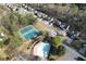 Beautiful aerial shot showcases community pool, tennis courts, and a well-kept neighborhood at 10715 Glenbarr Dr, Johns Creek, GA 30097
