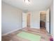 Spacious bedroom with hardwood floors, neutral paint, open doors to hallway and closet at 10715 Glenbarr Dr, Johns Creek, GA 30097