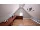 Bonus room with vaulted ceiling, wood-look floors, built-in desk, and ample natural light at 10715 Glenbarr Dr, Johns Creek, GA 30097