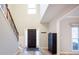 Bright foyer with a wood-look floor, high ceilings, decorative staircase and modern front door at 10715 Glenbarr Dr, Johns Creek, GA 30097