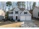 Charming two-story home boasts a well-manicured lawn, a two-car garage, and eye-catching architectural trim at 10715 Glenbarr Dr, Johns Creek, GA 30097