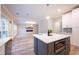 Open-concept kitchen showcasing quartz countertops, stainless steel appliances, and natural light, seamlessly connecting to adjacent living area at 10715 Glenbarr Dr, Johns Creek, GA 30097