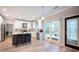 Open kitchen featuring stainless steel appliances, white cabinetry and an island with bar seating at 10715 Glenbarr Dr, Johns Creek, GA 30097