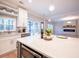 Open-concept kitchen showcasing quartz countertops, stainless steel appliances, and natural light, seamlessly connecting to adjacent living area at 10715 Glenbarr Dr, Johns Creek, GA 30097