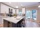 Modern kitchen featuring white cabinets, a center island with seating, and stainless steel appliances, offering both style and functionality at 10715 Glenbarr Dr, Johns Creek, GA 30097