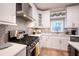 Modern kitchen featuring white cabinets, quartz countertops, and stainless steel appliances offers both style and functionality at 10715 Glenbarr Dr, Johns Creek, GA 30097