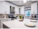 Modern kitchen featuring white cabinets, a center island with seating, and stainless steel appliances, offering both style and functionality at 10715 Glenbarr Dr, Johns Creek, GA 30097