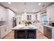 Modern kitchen featuring white cabinets, a center island with seating, and stainless steel appliances, offering both style and functionality at 10715 Glenbarr Dr, Johns Creek, GA 30097