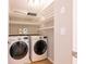 Well-organized laundry room with shelving and modern LG front-loading washer and dryer at 10715 Glenbarr Dr, Johns Creek, GA 30097