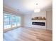 Inviting living room featuring a sleek electric fireplace and abundant natural light at 10715 Glenbarr Dr, Johns Creek, GA 30097
