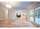 Open-concept living room with natural light, view to kitchen and backyard access at 10715 Glenbarr Dr, Johns Creek, GA 30097