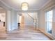 Open-concept living area with hardwood floors and a view of the staircase, creating an inviting space at 10715 Glenbarr Dr, Johns Creek, GA 30097