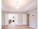 Main bedroom featuring a tray ceiling, wood-look floors and multiple interior doors at 10715 Glenbarr Dr, Johns Creek, GA 30097