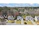 An aerial shot shows the neighborhood featuring lush trees surrounding the property, highlighting the location and curb appeal at 2130 Waters Ferry Dr, Lawrenceville, GA 30043