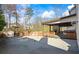 Inviting backyard featuring a concrete patio, covered deck with fireplace, and basketball court at 2130 Waters Ferry Dr, Lawrenceville, GA 30043
