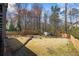 Backyard with a basketball court, fire pit, shed, and well-maintained lawn at 2130 Waters Ferry Dr, Lawrenceville, GA 30043