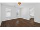 Bright bedroom with hardwood floors, two windows, and a walk-in closet offers a serene space at 2130 Waters Ferry Dr, Lawrenceville, GA 30043