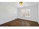 Bright, airy bedroom features hardwood floors, white trim, and natural light from the window, creating a welcoming retreat at 2130 Waters Ferry Dr, Lawrenceville, GA 30043