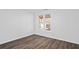 This bedroom features a large window, wood-look floors and base trim at 2130 Waters Ferry Dr, Lawrenceville, GA 30043