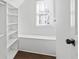 Walk-in closet with built-in shelving and a window seat, providing ample storage and natural light at 2130 Waters Ferry Dr, Lawrenceville, GA 30043