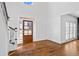 Inviting entryway with hardwood floors, shiplap accent wall, and natural light shining through the front door at 2130 Waters Ferry Dr, Lawrenceville, GA 30043
