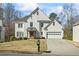 Beautiful two-story white brick home with a manicured lawn and a two-car garage on a sunny day at 2130 Waters Ferry Dr, Lawrenceville, GA 30043