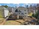 Rear exterior view showcasing the deck, covered patio, and pergola with fire pit at 2130 Waters Ferry Dr, Lawrenceville, GA 30043