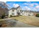 Charming two-story home featuring a manicured lawn and an expansive driveway leading to a two-car garage at 2130 Waters Ferry Dr, Lawrenceville, GA 30043