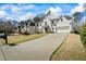 A beautiful two-story white brick home showcasing its manicured front yard and long driveway at 2130 Waters Ferry Dr, Lawrenceville, GA 30043