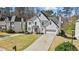 A well-maintained two-story home with a long driveway, attached two-car garage, and manicured front lawn at 2130 Waters Ferry Dr, Lawrenceville, GA 30043