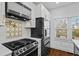 Well-equipped kitchen with stainless steel appliances, white cabinets, and a patterned backsplash for a modern design at 2130 Waters Ferry Dr, Lawrenceville, GA 30043