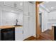 Modern kitchen featuring white cabinets, butcher block counters, tiled backsplash, and stainless steel appliances at 2130 Waters Ferry Dr, Lawrenceville, GA 30043