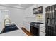 Modern kitchen featuring stainless steel appliances, white cabinets, and black countertops for a sleek look at 2130 Waters Ferry Dr, Lawrenceville, GA 30043