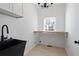 This laundry room has an undermount sink, butcher block, and tile floors at 2130 Waters Ferry Dr, Lawrenceville, GA 30043