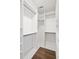 Spacious walk-in closet with custom shelving and hanging rods provides ample storage and organization at 2130 Waters Ferry Dr, Lawrenceville, GA 30043