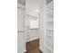 Spacious walk-in closet with custom shelving and hanging rods provides ample storage and organization at 2130 Waters Ferry Dr, Lawrenceville, GA 30043