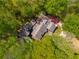 Aerial view of a secluded home with mature trees and roofing, offering privacy and natural beauty at 2977 Glover Dr, Cumming, GA 30040