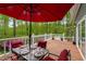 Relaxing back deck featuring an umbrella table, chairs and views of the surrounding forest at 2977 Glover Dr, Cumming, GA 30040