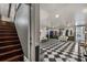 Finished basement area featuring a black and white checkered floor, staircase, and ample room for activities or storage at 2977 Glover Dr, Cumming, GA 30040