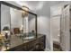 Elegant bathroom featuring a dark vanity, large mirror, and separate shower for a luxurious feel at 2977 Glover Dr, Cumming, GA 30040
