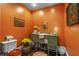 Charming half bathroom featuring a vanity with decorative accents and bright orange walls at 2977 Glover Dr, Cumming, GA 30040