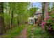 Charming home nestled in a lush, wooded setting with vibrant landscaping and a cozy deck at 2977 Glover Dr, Cumming, GA 30040