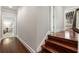 Elegant hallway featuring polished hardwood floors with white trim, leading to doorways that enhance the home's character at 2977 Glover Dr, Cumming, GA 30040