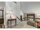 Bright hallway featuring a charming table with decorative elements leading to an open landing with a view into a bedroom at 2977 Glover Dr, Cumming, GA 30040